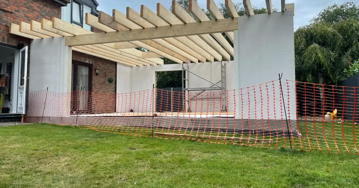 Modern rear extension with large glazed doors opening to garden - Mid Build