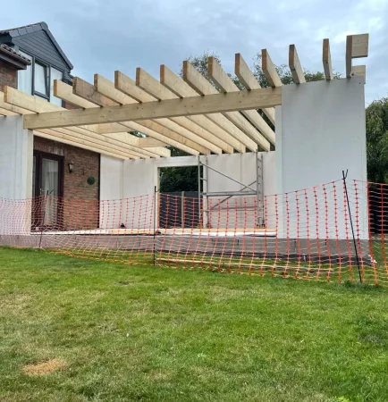 Modern rear extension with large glazed doors opening to garden - Mid Build